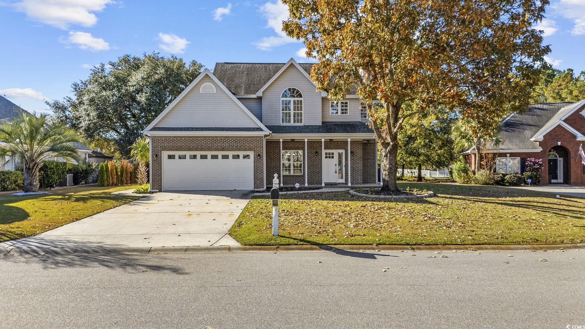 629 Slash Pine Court Myrtle Beach, SC 29579 - Photo 1 of 40 Traditional-style house with driveway, a front lawn, a porch, and brick siding