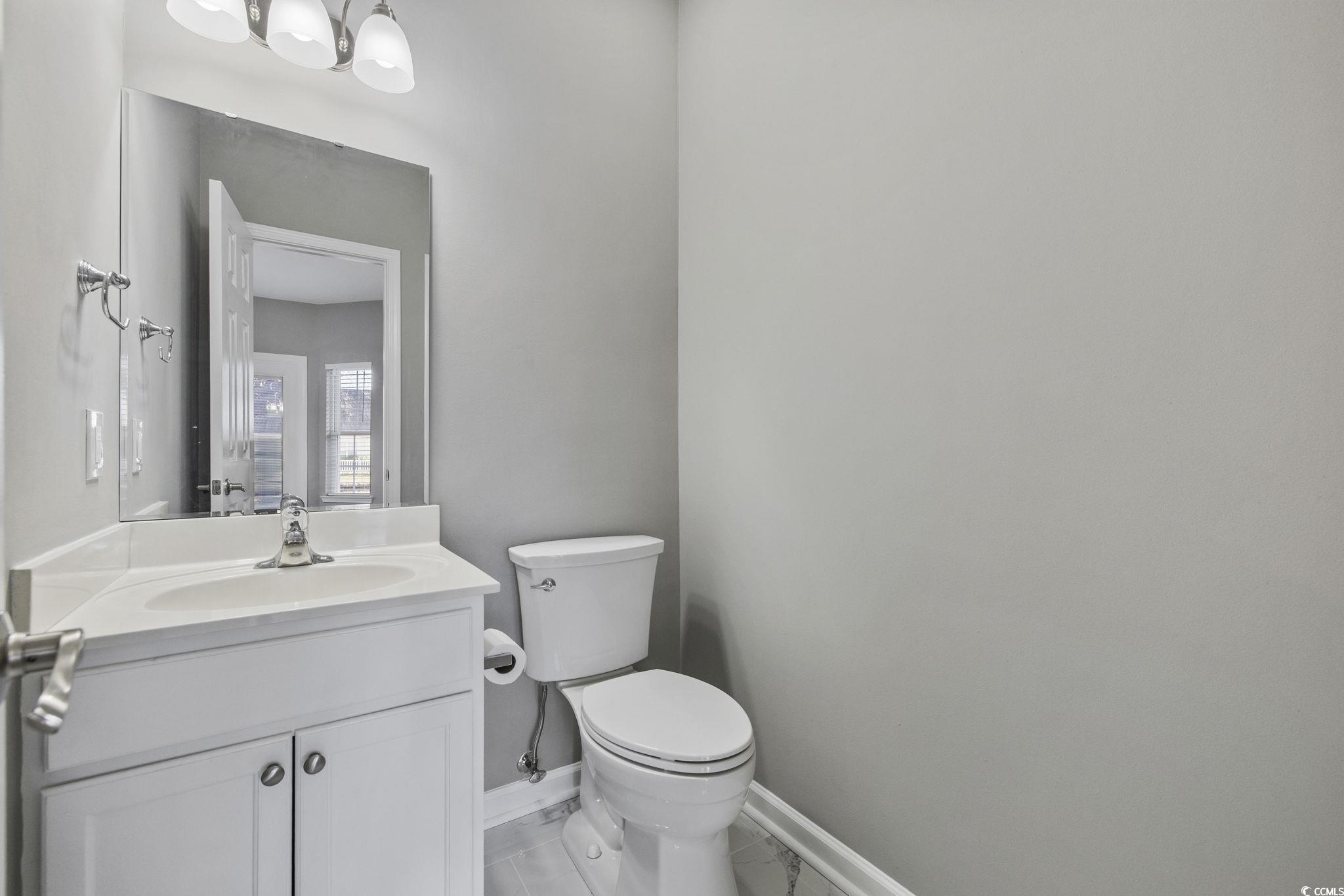 629 Slash Pine Court Myrtle Beach, SC 29579 - Photo 14 of 40 Half bathroom featuring vanity and baseboards