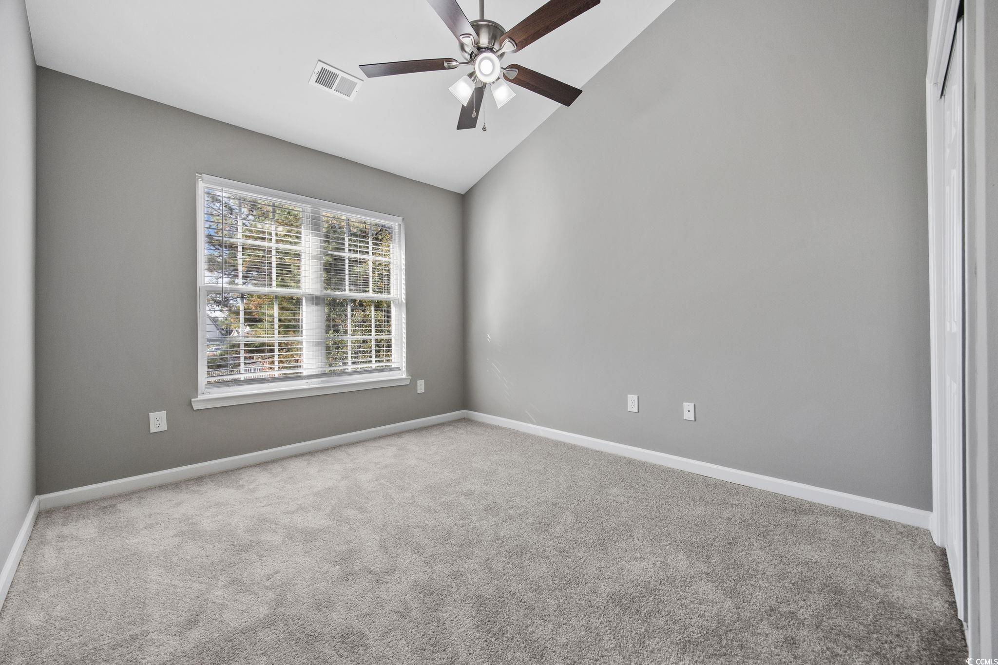 629 Slash Pine Court Myrtle Beach, SC 29579 - Photo 15 of 40 Empty room with carpet, a ceiling fan, and high vaulted ceiling