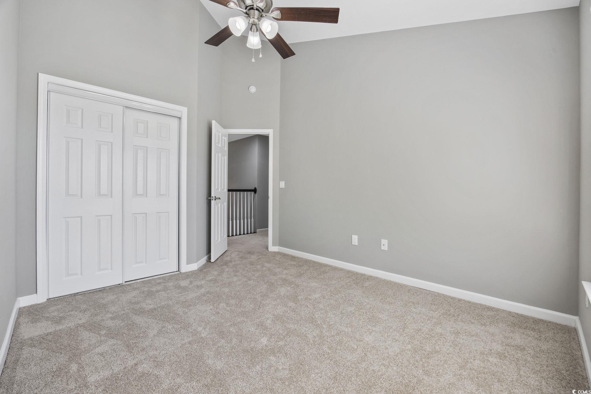 629 Slash Pine Court Myrtle Beach, SC 29579 - Photo 16 of 40 Unfurnished bedroom featuring a high ceiling, light carpet, a closet, and ceiling fan