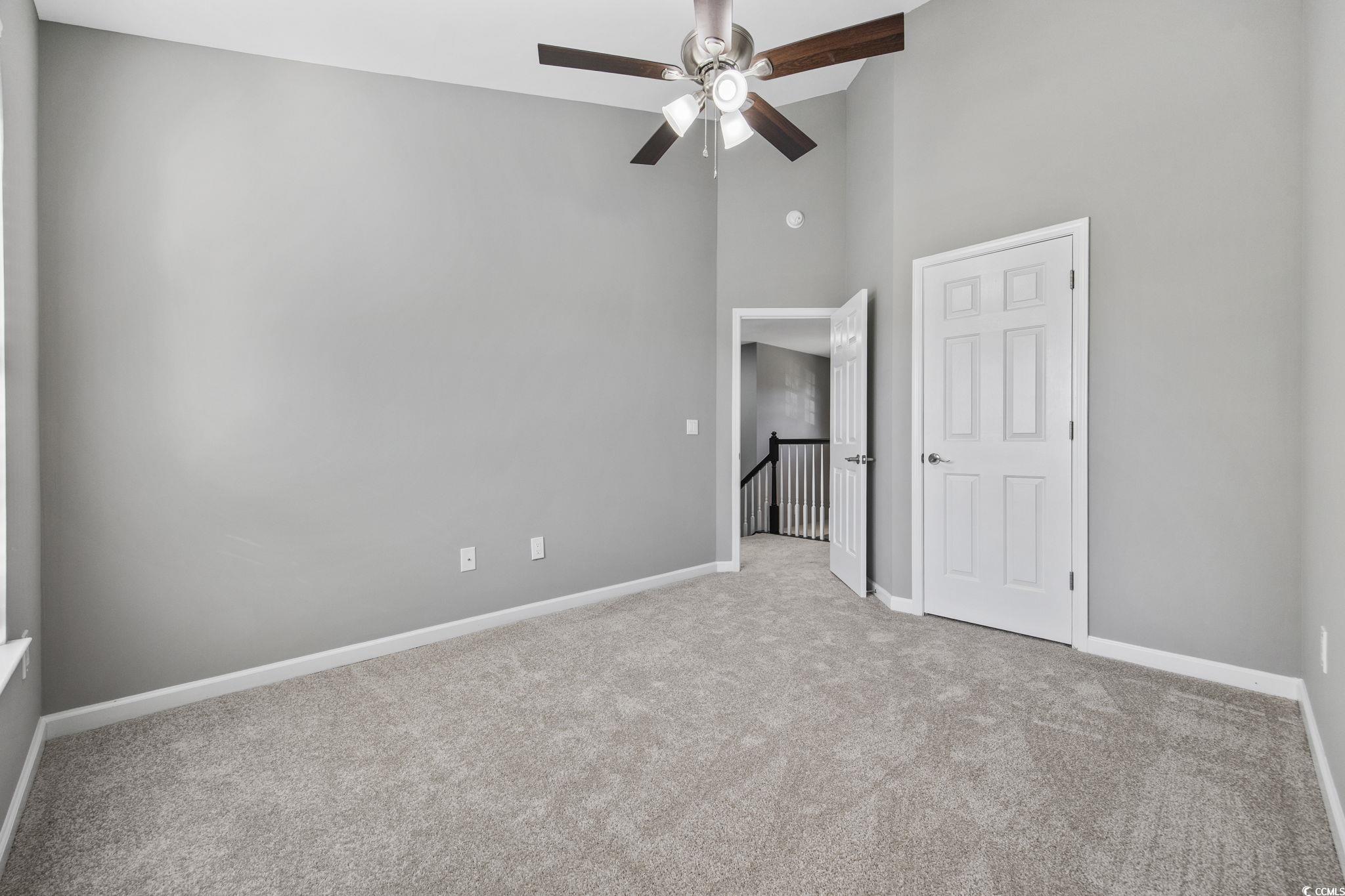 629 Slash Pine Court Myrtle Beach, SC 29579 - Photo 18 of 40 Unfurnished bedroom with a high ceiling, light colored carpet, and a ceiling fan