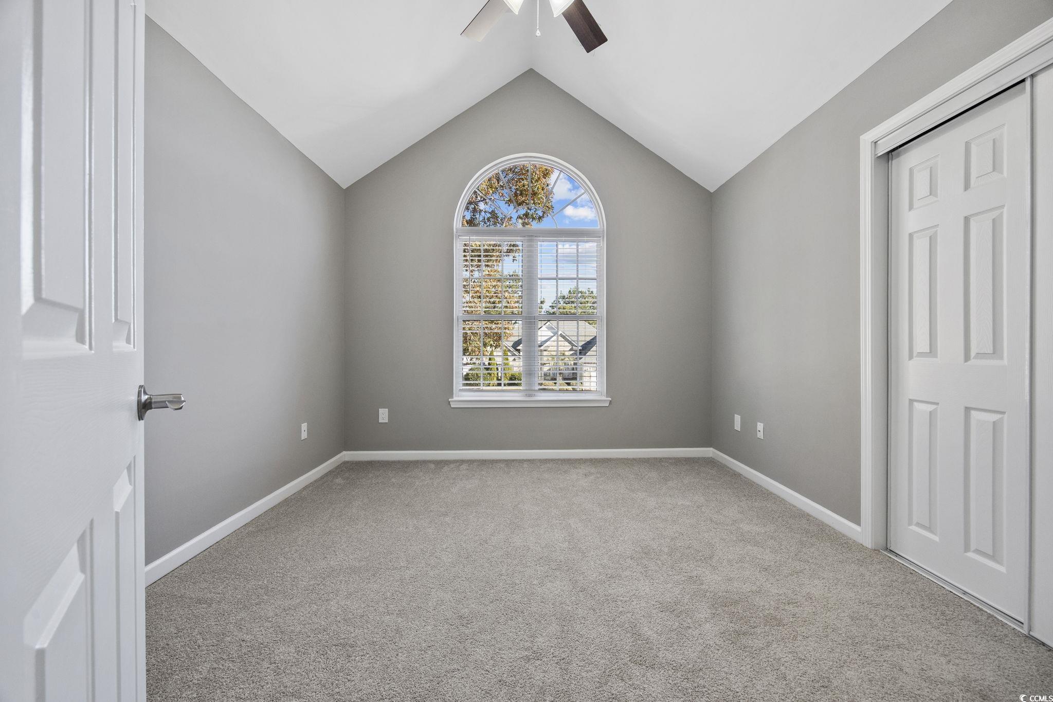 629 Slash Pine Court Myrtle Beach, SC 29579 - Photo 20 of 40 Unfurnished bedroom featuring light colored carpet, vaulted ceiling, a closet, and ceiling fan
