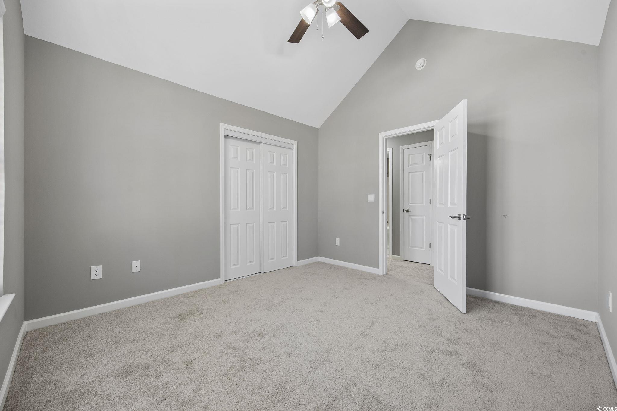 629 Slash Pine Court Myrtle Beach, SC 29579 - Photo 21 of 40 Unfurnished bedroom with high vaulted ceiling, light colored carpet, a closet, and ceiling fan