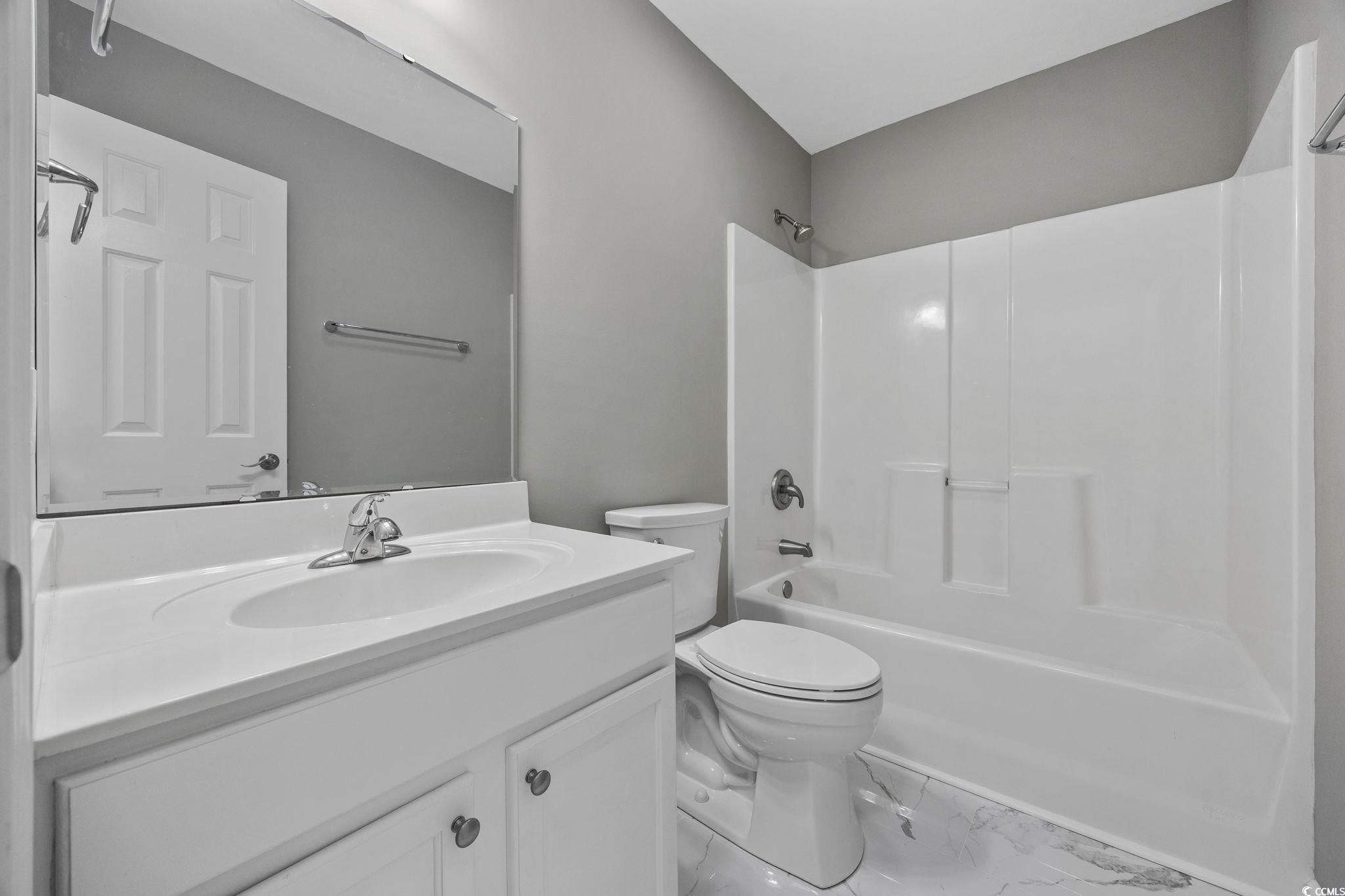 629 Slash Pine Court Myrtle Beach, SC 29579 - Photo 22 of 40 Full bathroom featuring bathing tub / shower combination, vanity, and marble look tile flooring