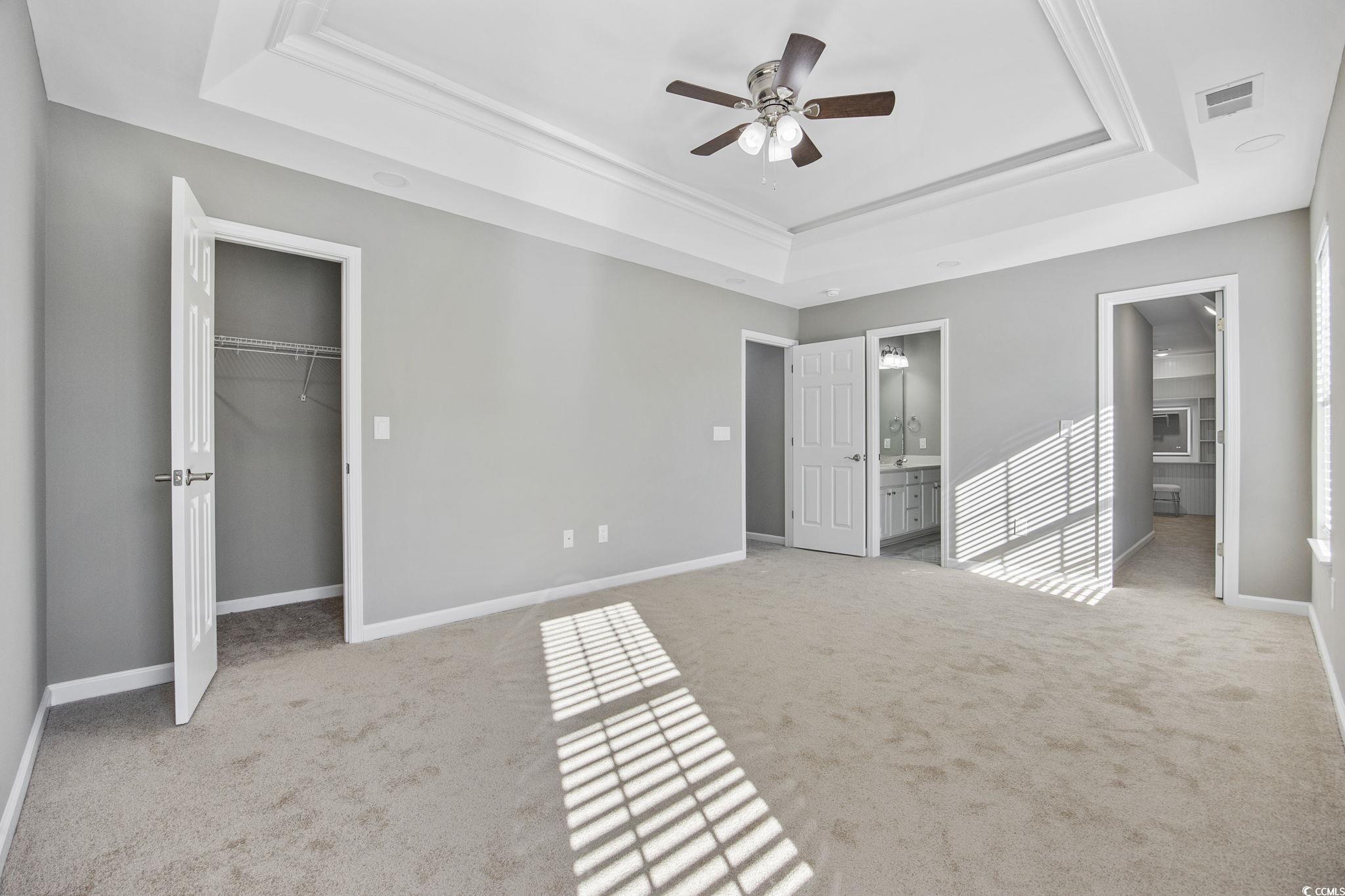 629 Slash Pine Court Myrtle Beach, SC 29579 - Photo 24 of 40 Unfurnished bedroom with a spacious closet, a raised ceiling, and light carpet