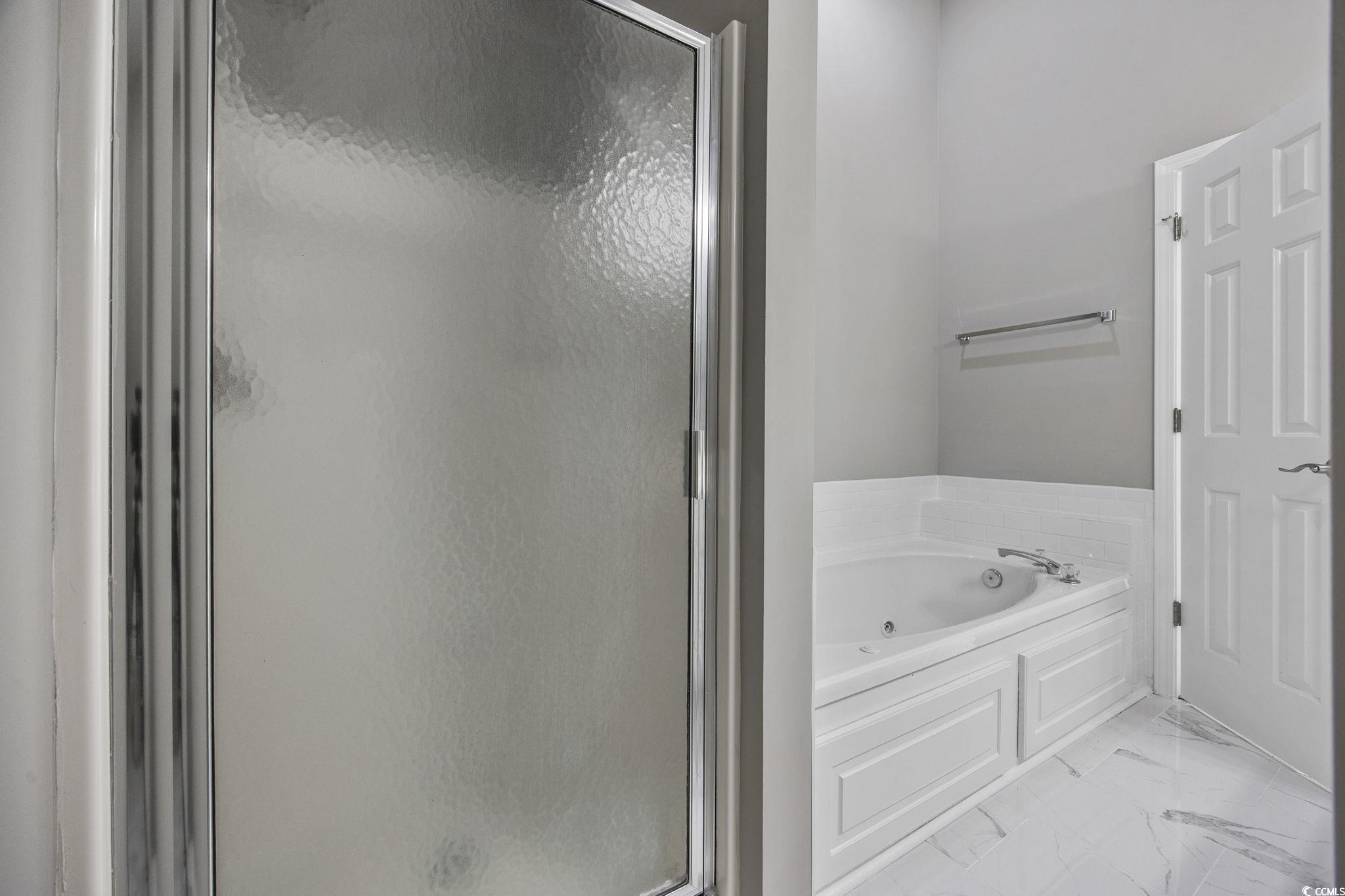629 Slash Pine Court Myrtle Beach, SC 29579 - Photo 27 of 40 Full bathroom featuring a whirlpool tub, a stall shower, and light marble finish flooring