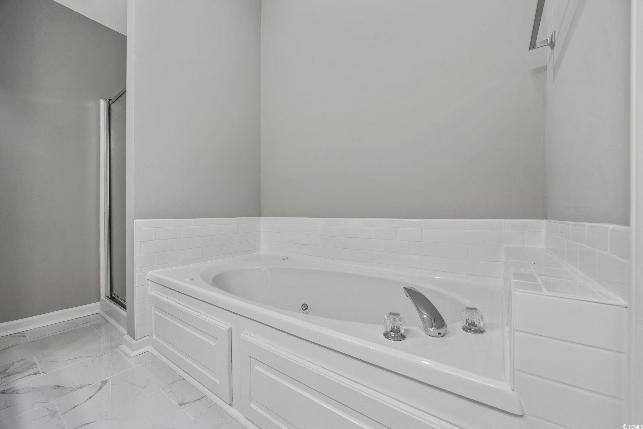 629 Slash Pine Court Myrtle Beach, SC 29579 - Photo 28 of 40 Full bathroom with a whirlpool tub, a stall shower, and light marble finish flooring