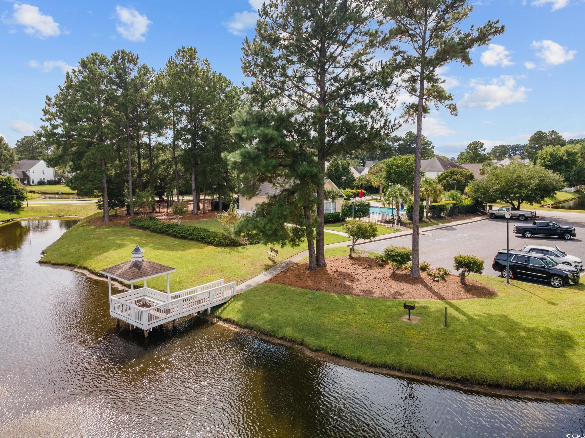 629 Slash Pine Court Myrtle Beach, SC 29579 - Photo 38 of 40 View of property's community with a water view, a lawn, and view of scattered trees