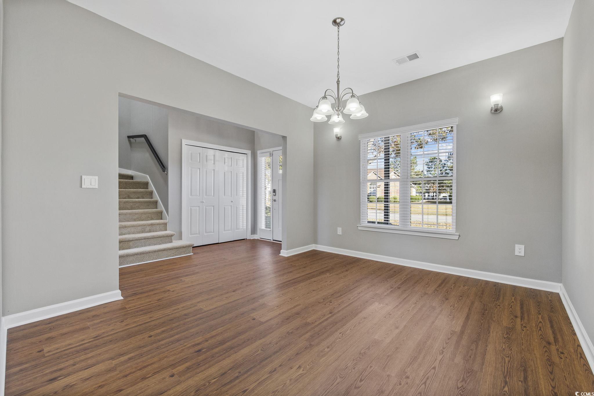629 Slash Pine Court Myrtle Beach, SC 29579 - Photo 6 of 40 Foyer entrance with dark wood-type flooring, stairway, and a chandelier