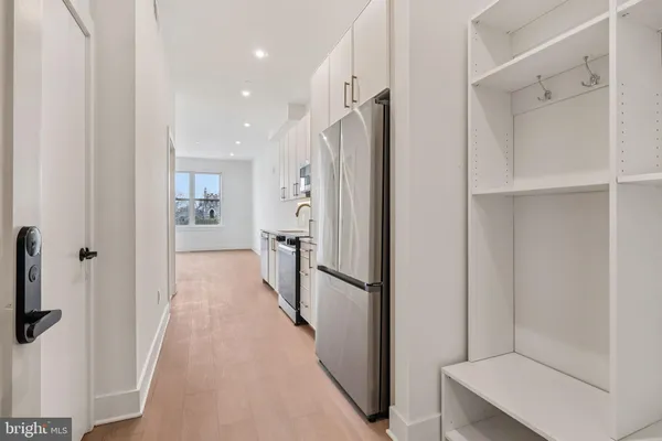 a view of a hallway with a refrigerator