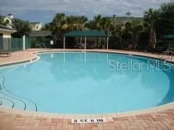 a view of a swimming pool with a yard