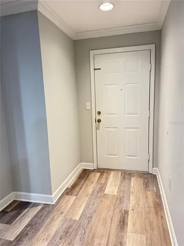 a view of room with wooden floor