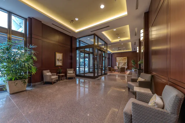 a lobby with furniture and a potted plant