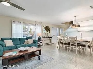 a living room with furniture and wooden floor