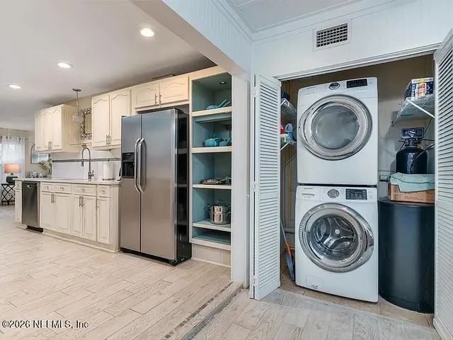 a utility room with sink dryer and washer