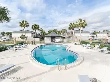 a view of a swimming pool with a lounge chairs
