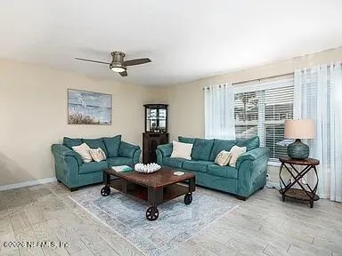 a living room with furniture and a large window