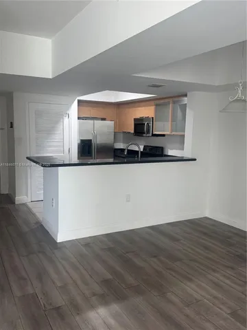 a kitchen with stainless steel appliances a sink and a microwave