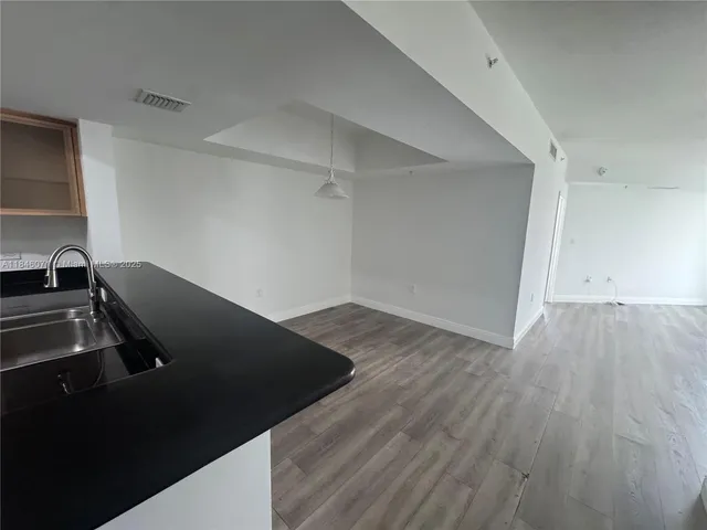 a view of a kitchen with wooden floor