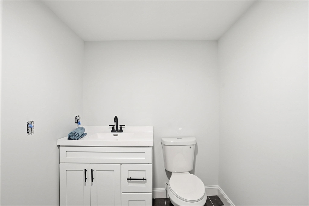 357 Wareham Street Middleboro, MA 02346 - Photo 30 of 42 a bathroom with a sink a toilet and a mirror