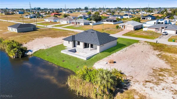 an aerial view of a house with a garden and swimming pool