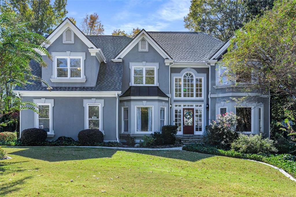a front view of a house with a yard and garage