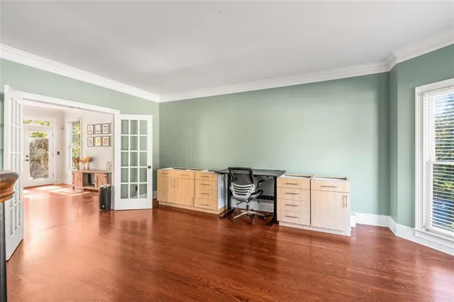 a view of a big room with chandelier and windows