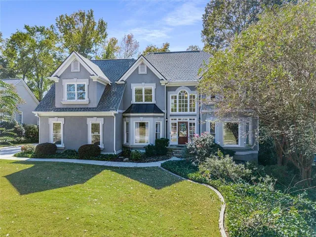 a front view of a house with garden