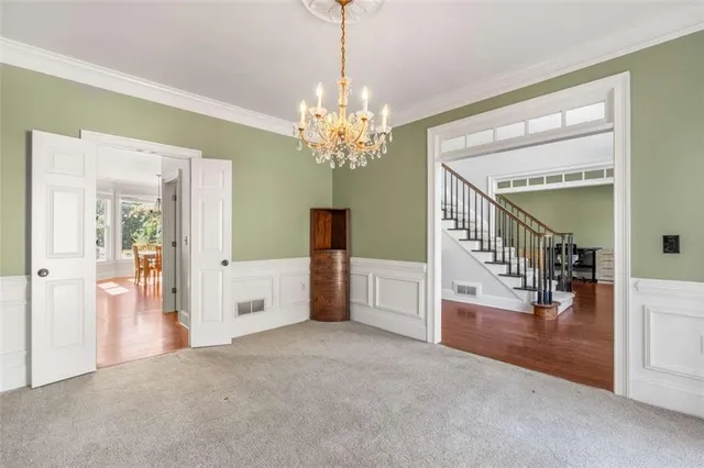 a bedroom with a large bed and a chandelier