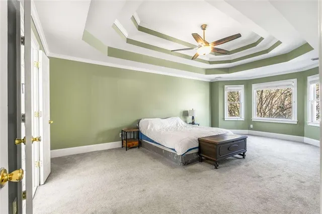 a bedroom with a large bed and a ceiling fan