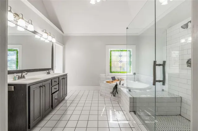 a bedroom with a bed a window and a chandelier