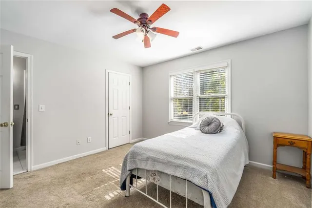 a spacious bathroom with a granite countertop sink mirror and a bathtub