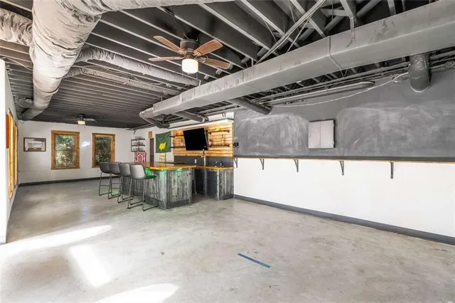 an aerial view of a house with a garden and large trees