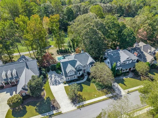 an aerial view of a house with yard swimming pool and outdoor seating