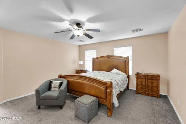 a living room with furniture and a ceiling fan