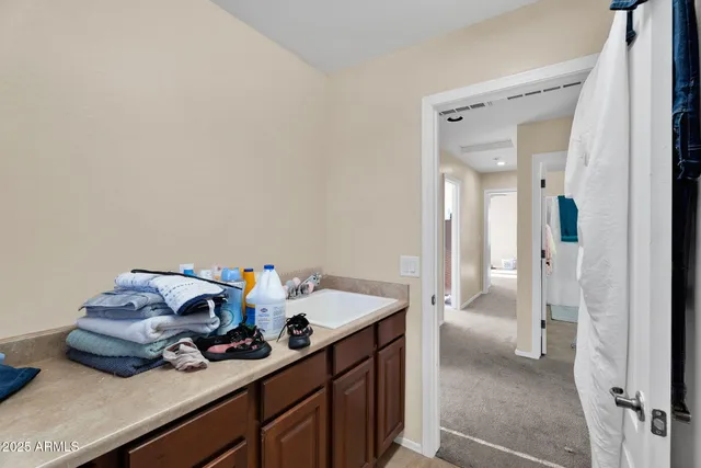 a bathroom with a double vanity sink toilet and mirror