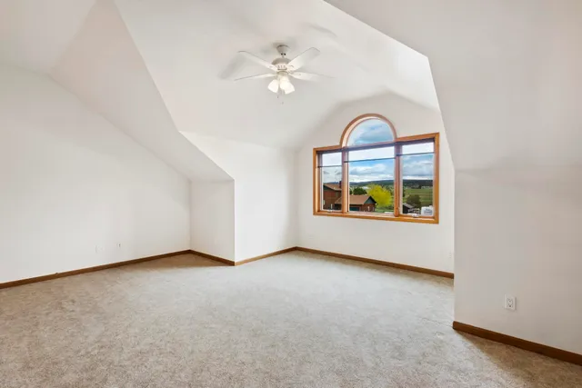 a view of a room with furniture and a ceiling fan