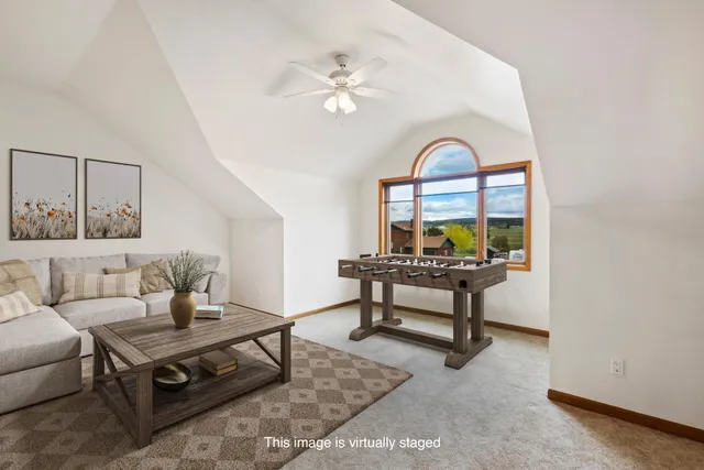 a living room with furniture a rug and a window