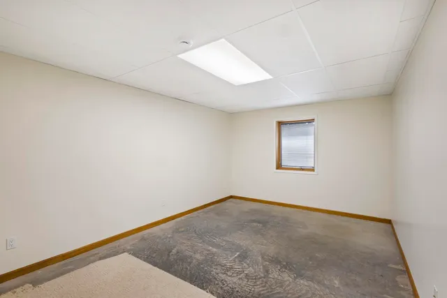 a bathroom with a granite countertop sink a toilet and shower