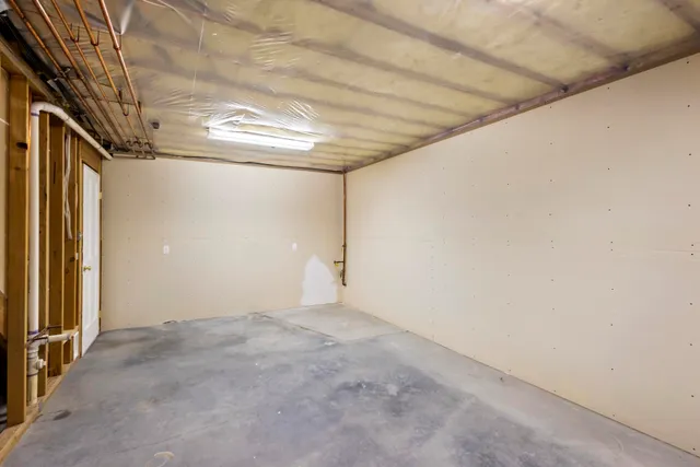 a view of empty room with wooden walls