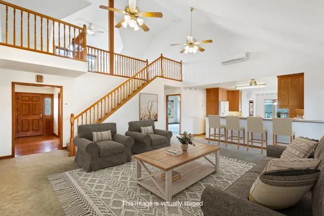 a living room with furniture and a chandelier
