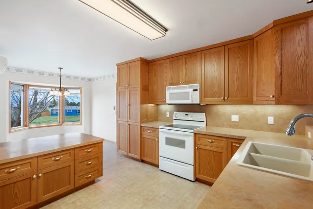 a kitchen with a sink cabinets and window