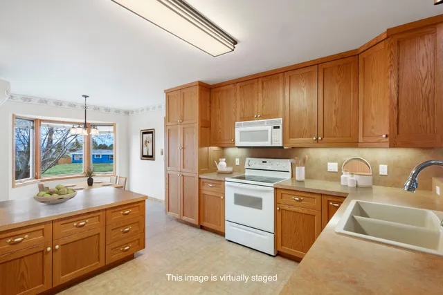 a kitchen with a sink stove and refrigerator