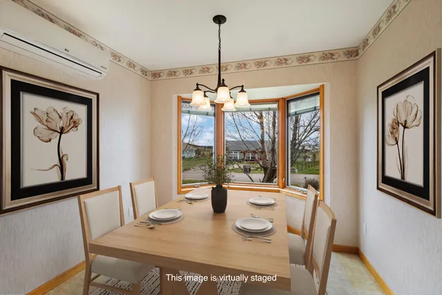 a view of a dining room with furniture large windows and wooden floor