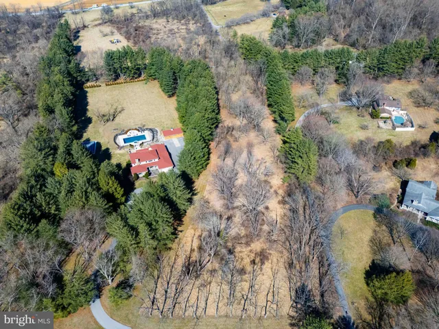 an aerial view of a house with a yard and garden