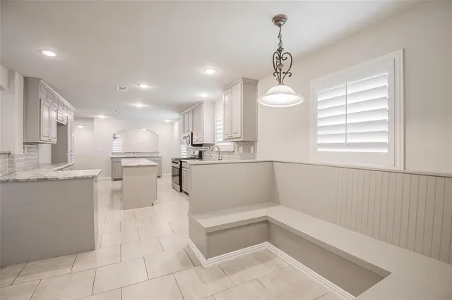 a view of kitchen with center island and stainless steel appliances