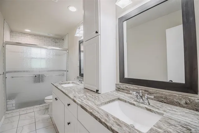a bathroom with a granite countertop sink mirror and double