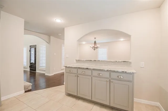 a spacious bathroom with a granite countertop sink and a mirror
