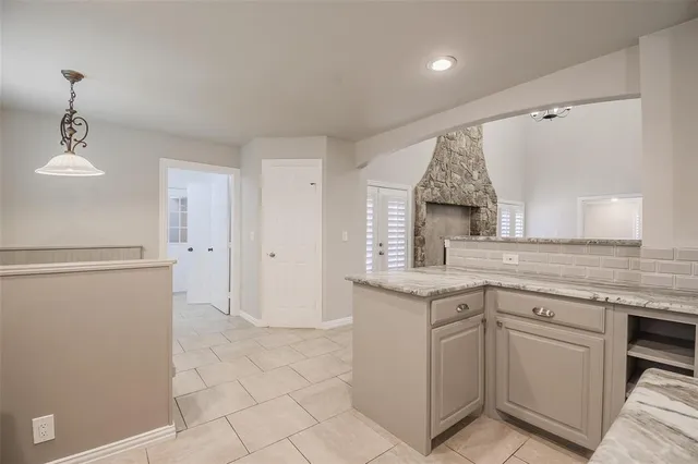 a kitchen with a sink window and cabinets