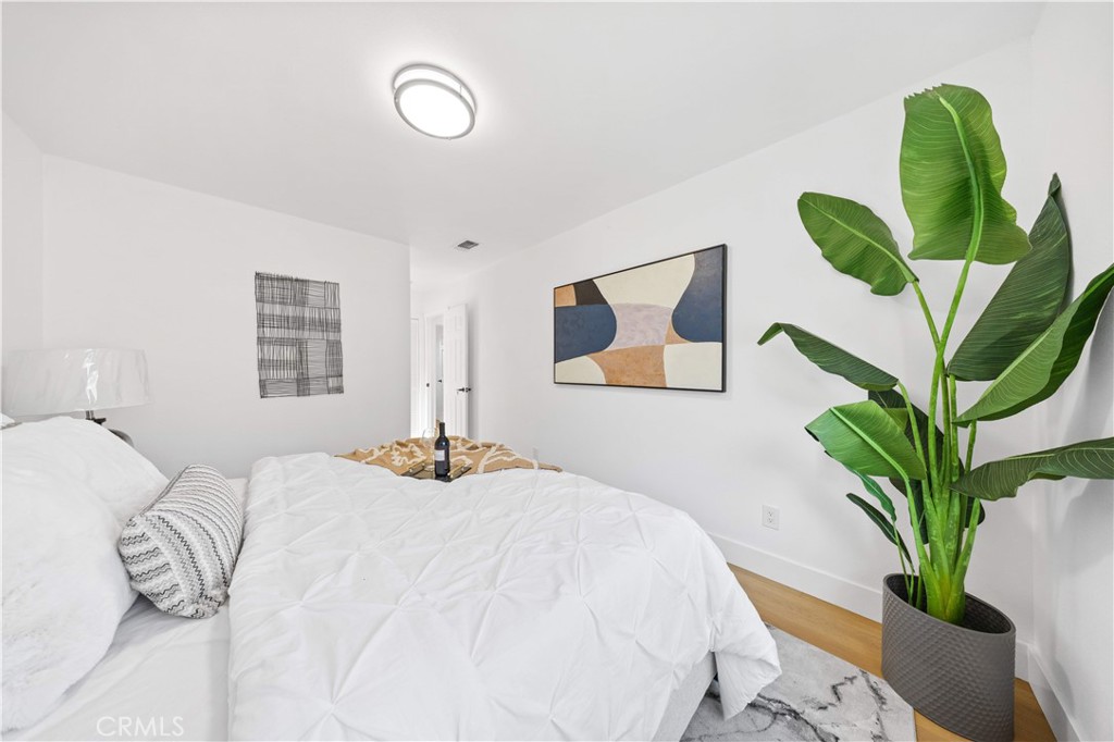 2274 Cogswell Road El Monte, CA 91732 - Photo 13 of 26 a bedroom with a large bed and a potted plant